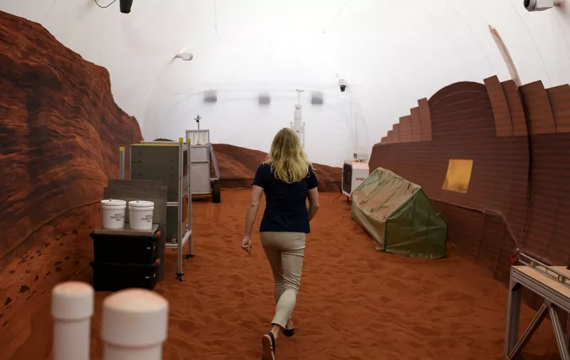 Dr. Suzanne Bell, Lead for NASAs Behavioral Health and Performance Laboratory, walks through a simulated Mars exterior portion of the CHAPEAs Mars Dune Alpha at the Johnson Space center in Houston, Texas on April 11, 2023. - CHAPEAs Mars Dune Alpha is a 3D printed habitat designed to serve as an analog for one-year missions. (Photo by Mark Felix / AFP)