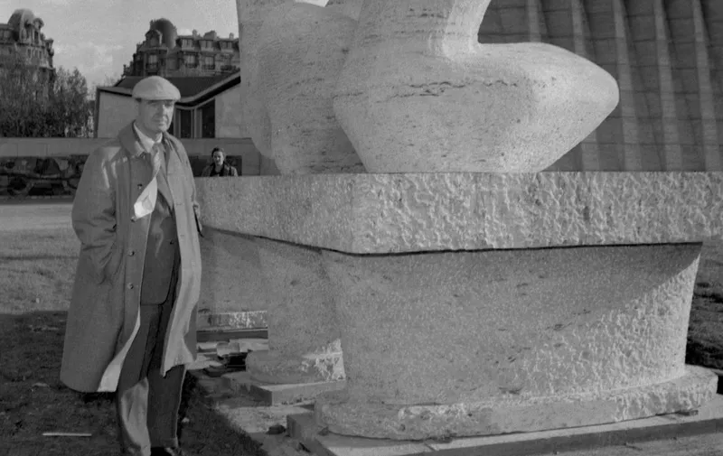 Henry Moore pictured 16 October 1958 standing next to his sculpture entitled "Silhouette au Repos" in front of the UNESCO headquarters in Paris. Henry Spencer Moore (30 July 1898 ñ 31 August 1986) was a British artist and sculptor. The son of a mining engineer, born in the Yorkshire town of Castleford, Moore became well known for his large-scale abstract cast bronze and carved marble sculptures. Substantially supported by the British art establishment, Moore helped to introduce a particular form of modernism into Britain. AFP PHOTO (Photo by ANP / AFP)