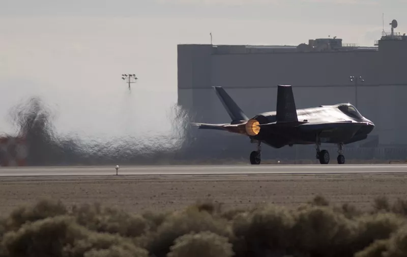 A Dutch Lockheed Martin F-35 Lightning II fighter jet takes off at Edwards Air Force Base, California, on November 24, 2015. The Lockheed Martin F-35 Lightning II is a family of single-seat, single-engine, all-weather stealth multirole fighters undergoing final development and testing for the United States and partner nations. The fifth generation combat aircraft is designed to perform ground attack and air defense missions.The program is the most expensive military weapons system in history, and it has been the object of much criticism from those inside and outside governmentin the US and in allied countries. (Photo by DAVID MCNEW / AFP)