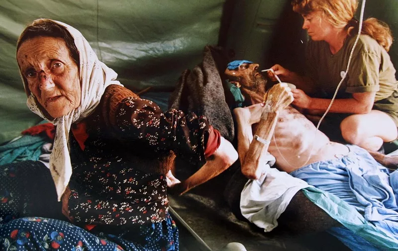 A picture taken on July 11, 1995 shows an elderly Muslim woman and her husband getting treatment for injuries inflicted on them by Serb military forces as they fled the east Bosnian enclave of Srebrenica. A Bosnian court on June 15, 2012 convicted four former elite soldiers of crimes against humanity for executing some 800 Bosnian Muslims during the 1995 Srebrenica massacre and sentenced them to up to 43 years. (The man on the right died shortly after the picture was taken). AFP PHOTO/Odd ANDERSEN (Photo by ODD ANDERSEN / AFP)