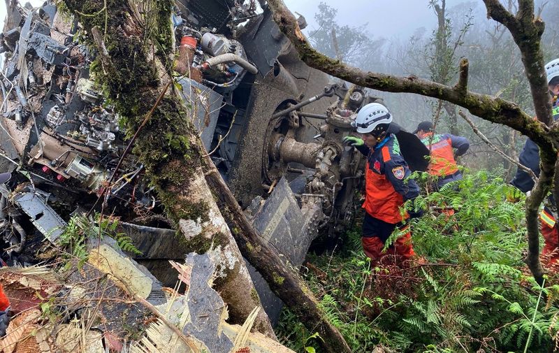 This handout picture released by the Yilan County Fire Department on January 2, 2020 shows rescuers searching for survivors after a military Black Hawk helicopter smashed into mountains in Yilan county near Taipei. - Taiwan's top military chief Shen Yi-ming was killed in the helicopter crash on January 2, the defence ministry said, just days before the island goes to polls to elect a new president. (Photo by Handout / Yilan County Fire Department / AFP) / -----EDITORS NOTE --- RESTRICTED TO EDITORIAL USE - MANDATORY CREDIT "AFP PHOTO / Yilan County Fire Department" - NO MARKETING - NO ADVERTISING CAMPAIGNS - DISTRIBUTED AS A SERVICE TO CLIENTS