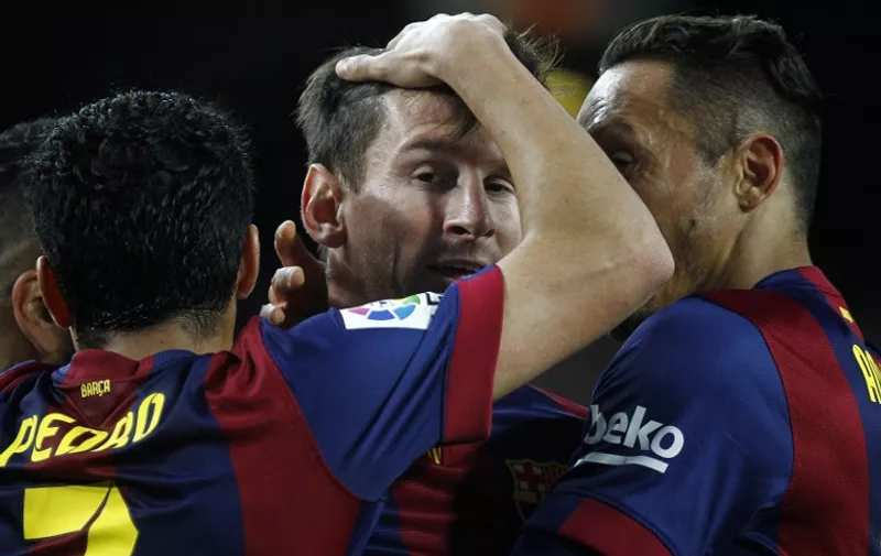 Barcelona&#8217;s Argentinian forward Lionel Messi (C) celebrates a gola with teammates Barcelona&#8217;s Brazilian defender Adriano (R) and Barcelona&#8217;s forward Pedro Rodriguez during the Spanish league football match FC Barcelona v UD Almeria at the Camp Nou stadium in Barcelona on April 8, 2015. AFP PHOTO /