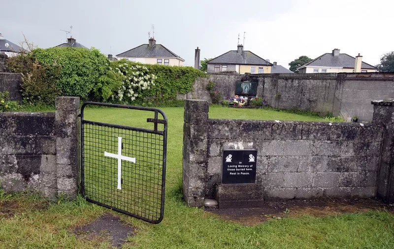 (FILES) In this file photo taken on June 09, 2014 shows a shrine in Tuam, County Galway, erected in memory of up to 800 children who were allegedly buried at the site of the former home for unmarried mothers run by nuns. - Some 9,000 children died in Ireland's historic "mother and baby homes" where unmarried mothers were separated from their infant offspring, an official report found on January 12, 2021. (Photo by PAUL FAITH / AFP)