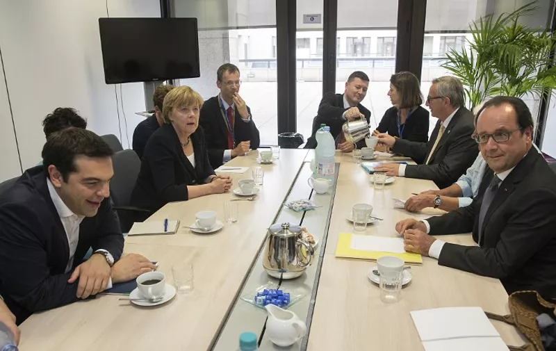 Greek Prime minister Alexis Tsipras (L), German Chancellor Angela Merkel (2ndL), European Commission President Jean-Claude Juncker (2ndR) and French President Francois Hollande (R) meet at the European Union (EU) headquarters in Brussels on July 7, 2015 ahead of an emergency EU summit after Greeks defiantly voted 'No' to further austerity. Greek Prime Minister is to face his 18 eurozone counterparts as the country's economy gasps for air, with banks closed until at least July 9 amid fears the Greek financial system is imploding.  AFP PHOTO / POOL / PHILIPPE WOJAZER