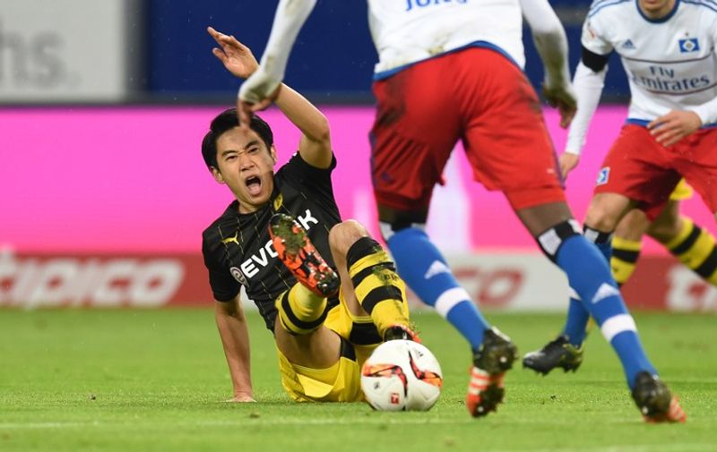 Dortmund's Japanese midfielder Shinji Kagawa vies for the ball during the German first division football Bundesliga match between Hamburg SV and Borussia Dortmund in Hamburg, northern Germany on November 20, 2015. 

RESTRICTIONS: DURING MATCH TIME: DFL RULES TO LIMIT THE ONLINE USAGE TO 15 PICTURES PER MATCH AND FORBID IMAGE SEQUENCES TO SIMULATE VIDEO. 
==RESTRICTED TO EDITORIAL USE ==
FOR FURTHER QUERIES PLEASE CONTACT THE DFL DIRECTLY AT + 49 69 650050. / AFP / CARMEN JASPERSEN
