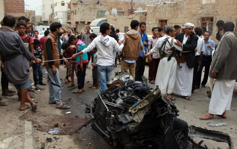 Yemenis gather at the site of a car bomb explosion near a mosque on July 29, 2015 in the capital Sanaa. Witnesses said the blast went off near a mosque of the Bohra sect of Shiite Islam, not far from Ath-Thawra Hospital in the Rammah district of Sanaa, where several attacks claimed by the Islamic State (IS) jihadist group have targeted Shiite rebels. "Two people were killed and four wounded according to a preliminary toll," a medical official said. AFP PHOTO / MOHAMMED HUWAIS