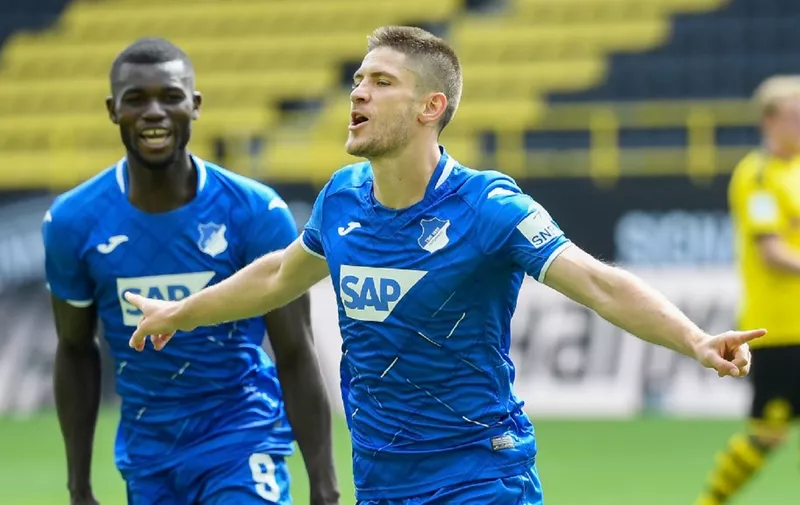 Hoffenheim's Croatian forward Andrej Kramaric (R) celebrates scoring his third goal during the German first division Bundesliga football match BVB Borussia Dortmund v TSG 1899 Hoffenheim on June 27, 2020 in Dortmund, western Germany. (Photo by Ina FASSBENDER / various sources / AFP) / DFL REGULATIONS PROHIBIT ANY USE OF PHOTOGRAPHS AS IMAGE SEQUENCES AND/OR QUASI-VIDEO