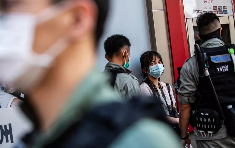 Police stop and search a woman (C) during a protest against China's planned national security law in Hong Kong on June 28, 2020.,Image: 536686150, License: Rights-managed, Restrictions: , Model Release: no
