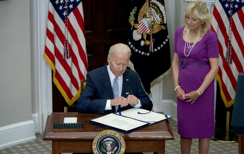 US First Lady Jill Biden looks on as US President Joe Biden signs the Bipartisan Safer Communities Act into law, in the Roosevelt Room of the White House in Washington, DC, on June 25, 2022. (Photo by Stefani Reynolds / AFP)