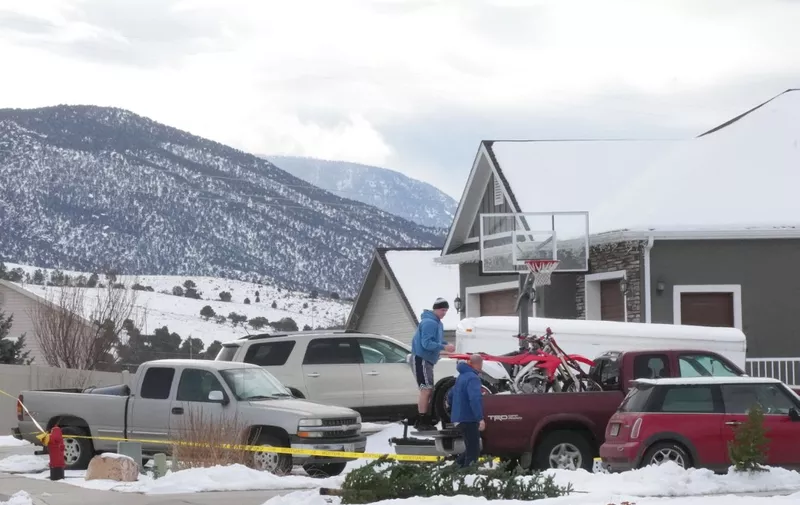 ENOCH, UT - JANUARY 05: Next door neighbors load up motorcycles into a truck next to the home of Michael Haight on January 5, 2023 in Enoch, Utah. Haight, who was 42, is accused of killing his wife, mother-in-law and his five kids that range in ages from 17 to 4 years old with a gun. The police say there are no additional suspects and the community is not in further danger.   George Frey/Getty Images/AFP (Photo by GEORGE FREY / GETTY IMAGES NORTH AMERICA / Getty Images via AFP)