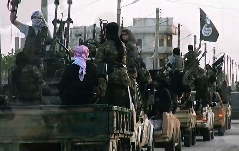 An image grab taken from a propaganda video released on March 17, 2014 by the Islamic State of Iraq and the Levant (ISIL)'s al-Furqan Media allegedly shows ISIL fighters driving on a street in the northern Syrian City of Homs. The jihadist Islamic State of Iraq and the Levant group has spearheaded a major offensive in Iraq that began on June 9, 2014 and has since overrun all of the northern Nineveh province. AFP PHOTO / HO / AL-FURQAN MEDIA 
=== RESTRICTED TO EDITORIAL USE - MANDATORY CREDIT "AFP PHOTO / HO / AL-FURQAN MEDIA" - NO MARKETING NO ADVERTISING CAMPAIGNS - DISTRIBUTED AS A SERVICE TO CLIENTS FROM ALTERNATIVE SOURCES, AFP IS NOT RESPONSIBLE FOR ANY DIGITAL ALTERATIONS TO THE PICTURE'S EDITORIAL CONTENT, DATE AND LOCATION WHICH CANNOT BE INDEPENDENTLY VERIFIED ===