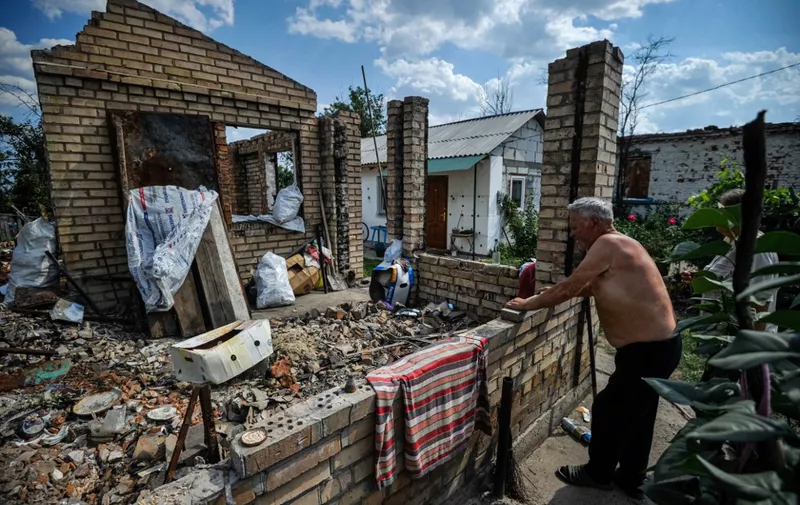 Vasily 68, looks at his destroyed house in the village of Andriivka, Kyiv region, on August 29, 2022, amid Russia's invasion of Ukraine. (Photo by SERGEI CHUZAVKOV / AFP)