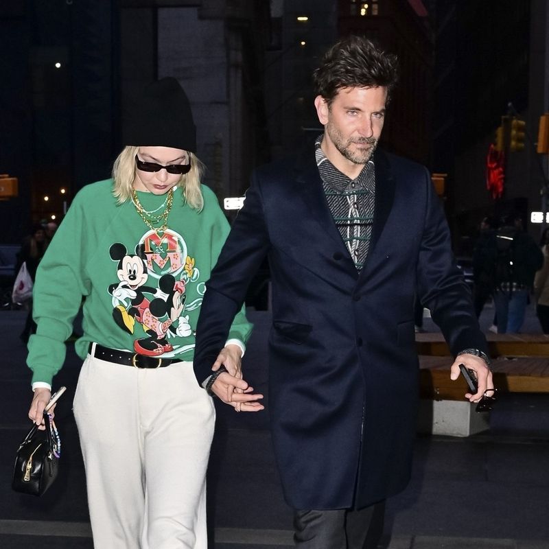 New York, NY  - *EXCLUSIVE*  - *Web Must Call For Pricing* Actor Bradley Cooper and model Gigi Hadid were spotted holding hands in the Wall Street area of New York City. Gigi who spent a full day shooting her latest campaign for Maybelline in the city cut a casual figure in wide leg pants, a green mickey mouse  jersey, MiuMiu bag and beanie.

BACKGRID USA 27 MARCH 2024,Image: 860032658, License: Rights-managed, Restrictions: , Model Release: no, Pictured: Bradley Cooper, Gigi Hadid