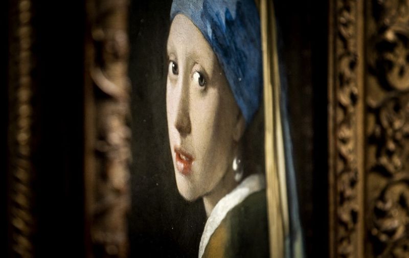 AMSTERDAM - The painting Girl with a Pearl Earring by Johannes Vermeer during the opening of the Vermeer exhibition in the Rijksmuseum. Guests from all over the Netherlands have been invited to the opening who have a link with the name Vermeer. The exhibition contains 28 of the 37 works made by Johannes Vermeer. ANP KOEN VAN WEEL netherlands out - belgium out (Photo by Koen van Weel / ANP MAG / ANP via AFP)