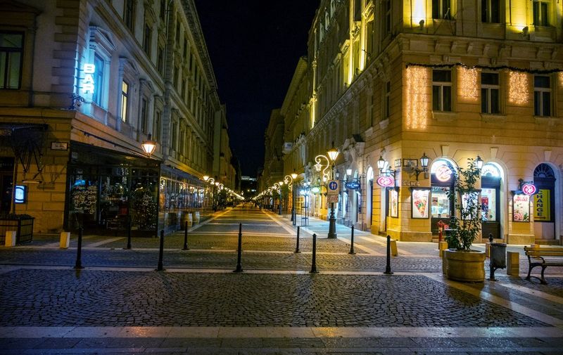 An empty shopping street near the Saint Stephan Basilica is seen during the curfew in Budapest on December 29, 2020, as Hungarians prepare to celebrate the New Year 2021 at their homes, amid the ongoing Covid-19 coronavirus pandemic. - Since November 11, 20202 Hungary is in a 2-months partial lockdown aimed at curbing the surge in coronavirus deaths. (Photo by ATTILA KISBENEDEK / AFP)