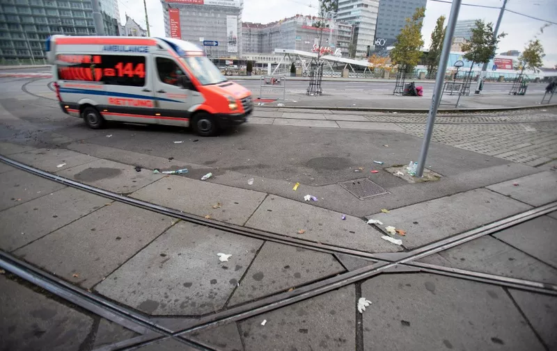 An ambulance drives past the medical aids left behind after the shooting at Schwedenplatz in downtown Vienna on November 3, 2020, after a shooting at multiple locations across central Vienna. Four people were killed in multiple shootings in Vienna on Monday evening, November 2, 2020, in what Austrian Chancellor Sebastian Kurz described as a "repulsive terror attack". (Photo by ALEX HALADA / AFP)