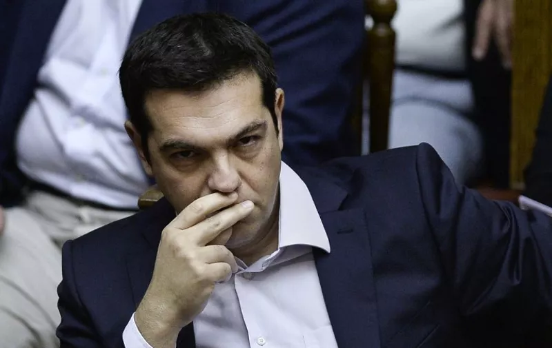 Greek Prime Minister Alexis Tsipras attends a parliamentary session in Athens on June 27, 2015. Greece will hold a referendum on July 5 on the outcome of negotiations with its international creditors taking place in Brussels on June 27, Prime Minister Alexis Tsipras announced. AFP PHOTO / ANGELOS TZORTZINIS