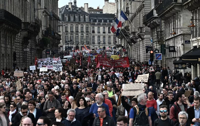 Protesters walk as they take part in a demonstration on a national action day, a week after the government pushed a pensions reform through parliament without a vote, using the article 49.3 of the constitution, in Bordeaux, western France, on March 23, 2023. - French President defiantly vowed to push through a controversial pensions reform on March 22, 2023, saying he was prepared to accept unpopularity in the face of sometimes violent protests. (Photo by Philippe LOPEZ / AFP)