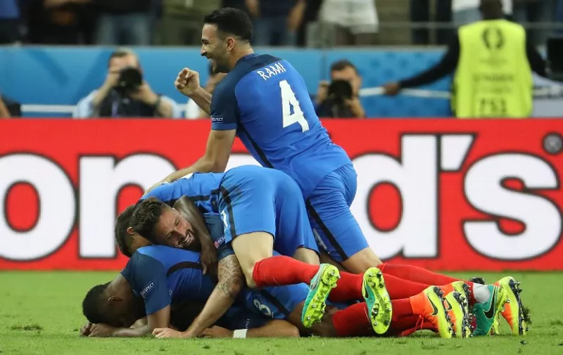 France's defender Adil Rami and teammates celebrate France's second goal during the Euro 2016 group A football match between France and Romania at Stade de France, in Saint-Denis, north of Paris, on June 10, 2016. / AFP PHOTO / KENZO TRIBOUILLARD