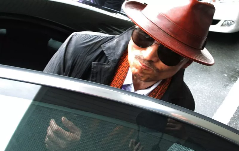 Kenichi Shinoda, the boss of Japan's largest "yakuza" gang, the Yamaguchi-gumi, gets into a car after arriving at the train station in Kobe, western Japan on April 9, 2011 after he was released from a Tokyo prison after serving time since 2005.  AFP PHOTO / JIJI PRESS