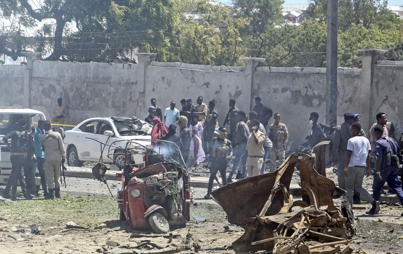 A general view of the scene of a car-bomb explosion in Mogadishu on January 12, 2022 where at least six people were killed and several others wounded in the huge blast that caused devastation in the area along the 21st October road. - At least six people were killed and undisclosed number of others wounded after a huge car bomb explosion rocked along a road in southern Mogadishu causing casualties and devastation. (Photo by AFP)