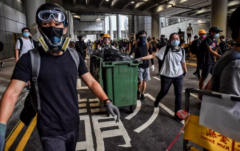 Protesters build barricades at Hong Kong International Airport on September 1, 2019. - Hundreds of Hong Kong pro-democracy activists attempted to block transport routes to the city's airport on September 1, as the financial hub began cleaning up after another night of serious violence marked by fires, tears gas and police beatings. (Photo by Lillian SUWANRUMPHA / AFP)