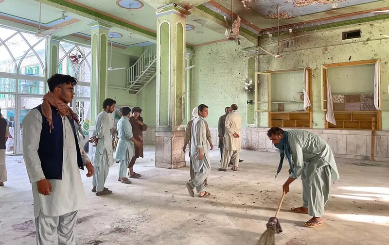 Afghan men inspect the damages inside a Shiite mosque in Kandahar on October 15, 2021, after a suicide bomb attack during Friday prayers that killed at least 33 people and injured 74 others, Taliban officials said. (Photo by JAVED TANVEER / AFP)