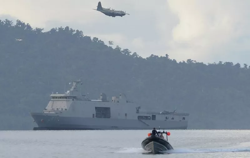 A Philippine air force C-130 cargo plane flies over Philippine navy sea lift vessel BRP Tarlac, while a speed boat loaded with US and Philippine marines sails during a simulation of a disaster drill as part of the annual joint Philippines-US military exercise at a sea port in Casiguran town, Aurora province on May 15, 2017.
The Philippines and the United States launched annual military exercises on May 8, but the longtime allies scaled them down in line with President Rodrigo Duterte's pivot to China and Russia. / AFP PHOTO / TED ALJIBE
