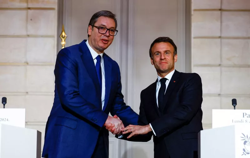 France's President Emmanuel Macron (R) shakes hands with Serbia's President Aleksandar Vucic (L) during a joint statement ahead of a working dinner at the presidential Elysee Palace in Paris on April 8, 2024. The two heads of state are expected to discuss issues including Serbia's European integration and relations between Belgrade and Kosovo. (Photo by Sarah Meyssonnier / POOL / AFP)