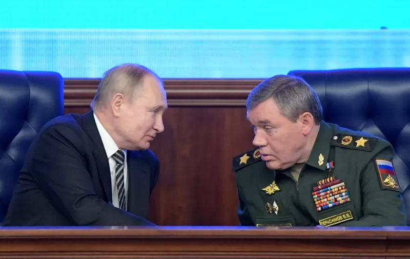 (FILES) In this file photo taken on December 21, 2021 Russian President Vladimir Putin listens to Chief of the General Staff of the Russian Armed Forces Valery Gerasimov during the annual meeting of the Defence Ministry board in Moscow. - Russia has again replaced its military commander in Ukraine, putting army chief Valery Gerasimov in charge of its forces in the conflict, the defence ministry said January 11, 2023. (Photo by Sergei GUNEYEV / SPUTNIK / AFP)