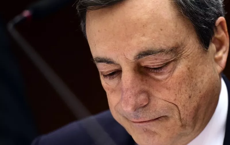 European Central Bank President Mario Draghi looks on before delivering introductory remarks in front of the Economic and Monetary Affairs Committee at the European Parliament, in Brussels, on March 23, 2015. AFP PHOTO / EMMANUEL DUNAND