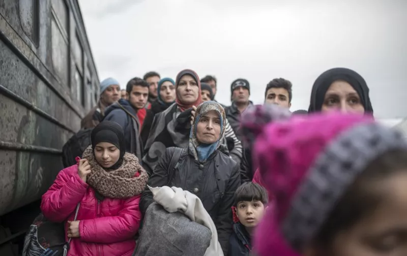 Migrants and refugees board a train heading to Serbia from the Macedonian-Greek border near Gevgelija  on February 18, 2016.
Macedonia has begun building a new razor-wire fence parallel to an existing one on the Greek border to make it harder for migrants to enter illegally. The police chiefs of five countries on the migrant route through southeast Europe announced a new agreement on February 18 for a coordinated registration point for refugees at the Greek-Macedonian border / AFP / Robert ATANASOVSKI