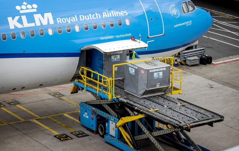 Onboard catering is loaded on a KLM plane on July 7, 2022 at Amsterdam's Schiphol Airport which, faced with staff shortages, was forced to announce in June 2022 that it would be limiting traveller numbers this summer and cancelling flights. (Photo by Koen van Weel / ANP / AFP) / Netherlands OUT