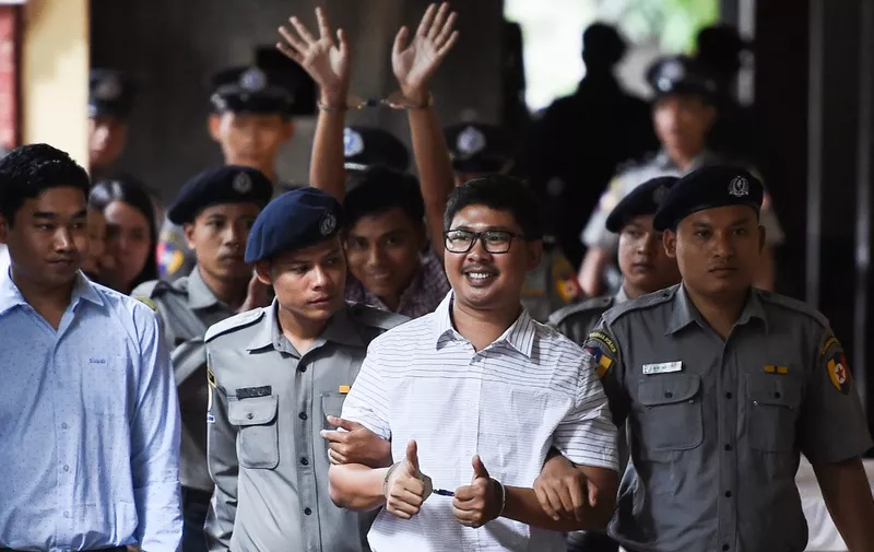 (FILES) In this file photo taken on August 27, 2018, Reuters journalists Wa Lone (front) and Kyaw Soe Oo (C-back) arrive in court in Yangon to face their verdict on charges linked to their reporting of the Rohingya crisis. - Myanmar's Supreme Court on April 23, 2019 rejected an appeal by the two Reuters journalists jailed for seven years on charges linked to their reporting on the Rohingya crisis, a defence lawyer confirmed. (Photo by Ye Aung THU / AFP)