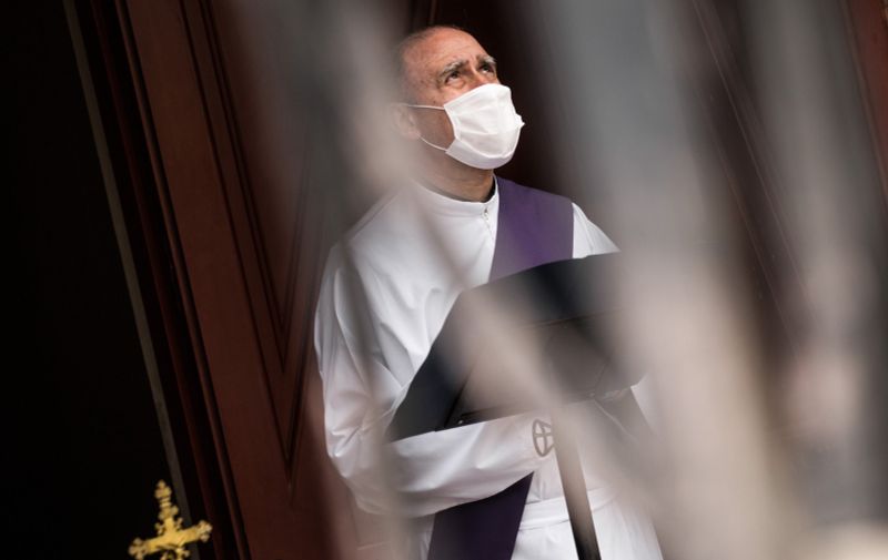 6216108 07.04.2020 Deacon of La Almudena cemetery Santiago wearing a protective face mask waits to perform funeral rites in Madrid, Spain. Until the present day, COVID-19 numbers in Spain are 141,942 infected people and 14,045 deaths., Image: 512966843, License: Rights-managed, Restrictions: , Model Release: no, Credit line: Alejandro Martinez Velez / Sputnik / Profimedia