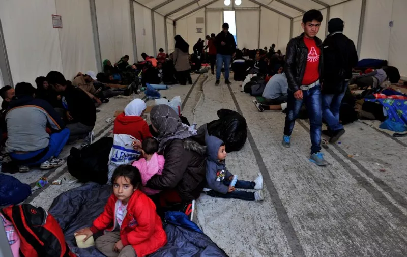 Migrants and refugees waiting to cross Greek-Macedonian border wait under a tent in a camp near the village of Idomeni, in northern Greece on October 14, 2015. More than 400,000 refugees, mostly Syrians and Afghans, arrived in Greece since early January while dozens were drowned trying to make the crossing. In total 710,000 have entered the EU through Greece and Italy during the same period, according to the European Agency Frontex border surveillance. The migration issue has caused deep divisions within the European Union, which is trying to set the distribution of migrants among its member countries or limit the flow.  AFP PHOTO /STRINGER