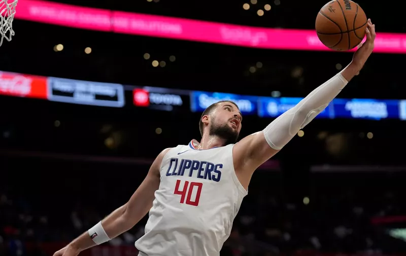 Los Angeles Clippers center Ivica Zubac (40) reaches for a rebound during the first half of a preseason NBA basketball game against the Denver Nuggets in Los Angeles, Tuesday, Oct. 17, 2023. (AP Photo/Ashley Landis)