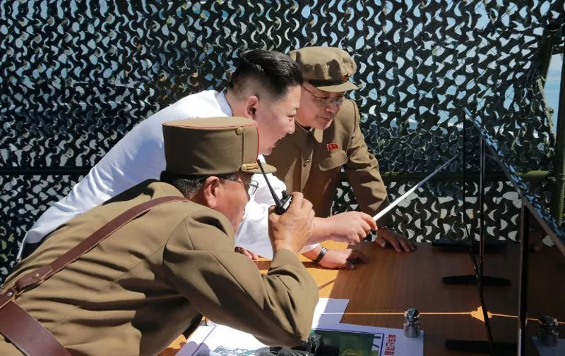This undated picture released from North Korea's official Korean Central News Agency (KCNA) on September 20, 2016 shows North Korean leader Kim Jong-Un (C) inspecting the ground jet test of a new type high-power engine of a carrier rocket for the geo-stationary satellite at the Sohae Space Center in North Korea.
North Korea has successfully tested a new, high-powered rocket engine, state media said, a move Seoul said was designed to showcase its progress towards being able to target the US east coast. / AFP PHOTO / KCNA / KCNA