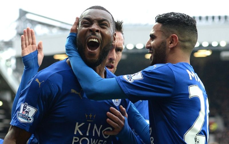 Leicester City's English defender Wes Morgan (L) celebrates scoring the equalising 1-1 goal with Leicester City's Algerian midfielder Riyad Mahrez (R) during the English Premier League football match between Manchester United and Leicester City at Old Trafford in Manchester, north west England, on May 1, 2016. / AFP PHOTO / OLI SCARFF / RESTRICTED TO EDITORIAL USE. No use with unauthorized audio, video, data, fixture lists, club/league logos or 'live' services. Online in-match use limited to 75 images, no video emulation. No use in betting, games or single club/league/player publications.  /