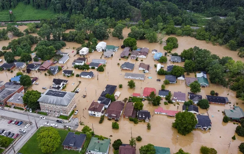 Aerial view of homes submerged under flood waters from the North Fork of the Kentucky River in Jackson, Kentucky, on July 28, 2022. - Flash flooding caused by torrential rains has killed at least eight people in eastern Kentucky and left some residents stranded on rooftops and in trees, the governor of the south-central US state said Thursday. (Photo by LEANDRO LOZADA / AFP)