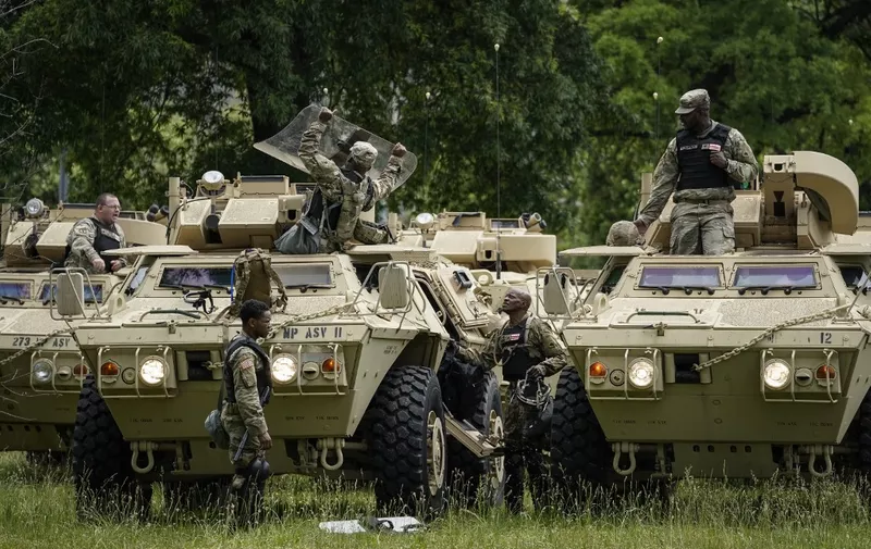 WASHINGTON, DC - JUNE 02: Members of the National Guard Military Police board armored personnel carriers at the Joint Force Headquarters of the D.C. National Guard on June 2, 2020 in Washington, DC. Protests continue to be held in cities throughout the country over the death of George Floyd, a black man who died in police custody in Minneapolis on May 25.   Drew Angerer/Getty Images/AFP