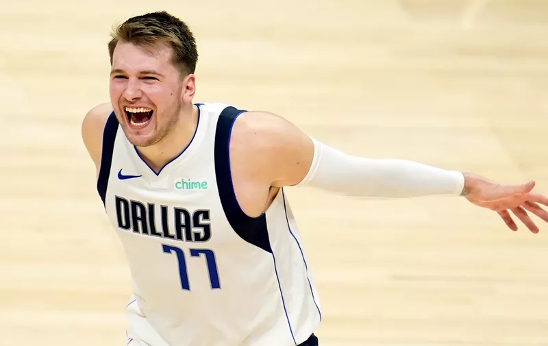 Dallas Mavericks guard Luka Doncic (77) celebrates in the closing minutes of a win over the Los Angeles Clippers during Game 2 of an NBA basketball first-round playoff series Tuesday, May 25, 2021, in Los Angeles. (AP Photo/Marcio Jose Sanchez)