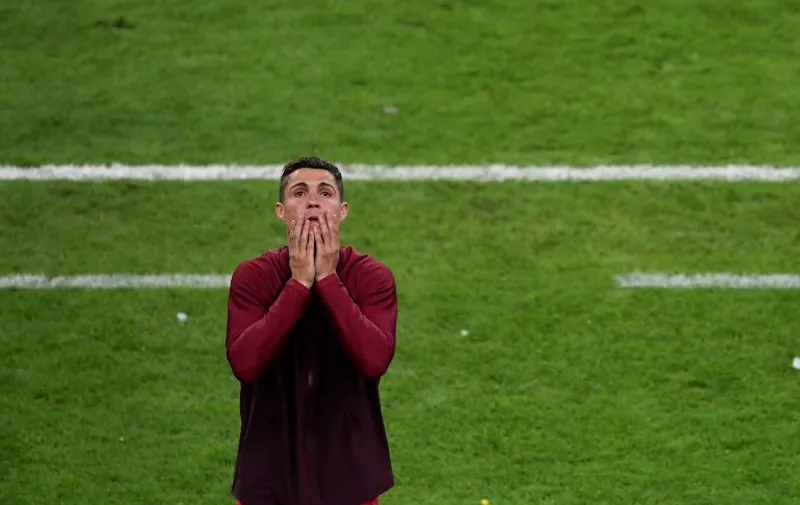 Portugal's forward Cristiano Ronaldo reacts during the Euro 2016 final football match between Portugal and France at the Stade de France in Saint-Denis, north of Paris, on July 10, 2016. / AFP PHOTO / MIGUEL MEDINA