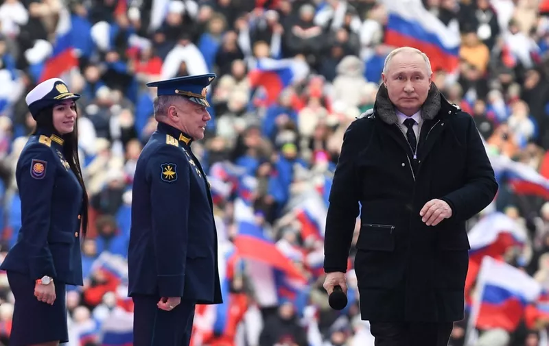 Russian President Vladimir Putin attends a patriotic concert dedicated to the upcoming Defender of the Fatherland Day at the Luzhniki stadium in Moscow on February 22, 2023. (Photo by Maksim BLINOV / SPUTNIK / AFP)