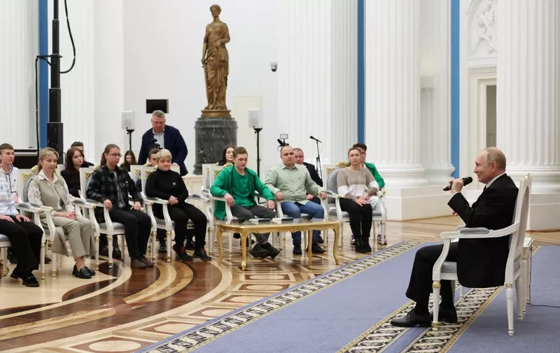 In this pool photograph distributed by Russia's state agency Sputnik, Russian President Vladimir Putin meets with winners of Russian professional skills championship at the Kremlin in Moscow on December 18, 2023. (Photo by Mikhail KLIMENTYEV / POOL / AFP)