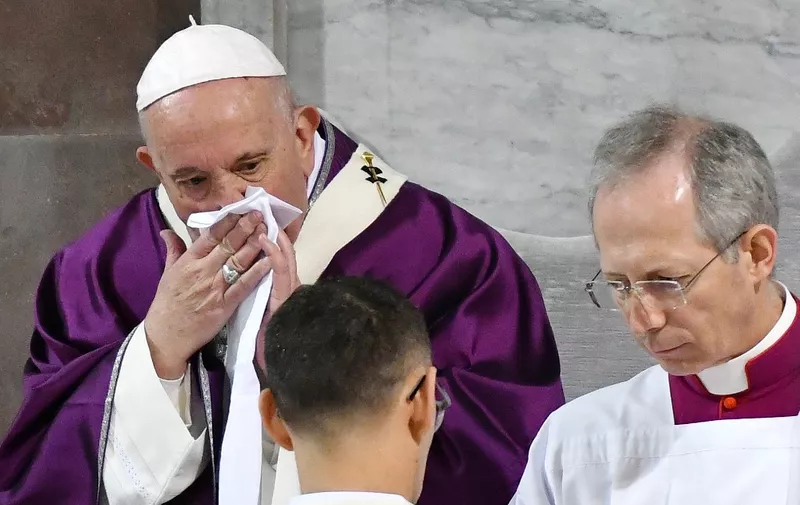 Pope Francis wipes his nose during the Ash Wednesday mass which opens Lent, the forty-day period of abstinence and deprivation for Christians before Holy Week and Easter, on February 26, 2020, at the Santa Sabina church in Rome. - Pope Francis postponed his official appointments on February 28 and was working from home, the Vatican said, a day after cancelling a scheduled appearance at mass because of "a mild ailment". Francis, 83, had appeared earlier in the week to be suffering from a cold. He was seen blowing his nose and coughing during the Ash Wednesday service, and his voice sounded hoarse. (Photo by Alberto PIZZOLI / AFP)