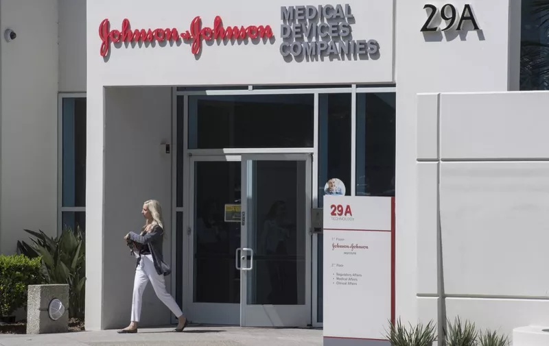 A woman leaves a building at the Johnson &amp; Johnson campus in Irvine, California on August 28, 2019. - The US pharmaceutical industry faces tens of billions of dollars in potential damage payments for fueling the opioid addiction crisis after Oklahoma won a $572 million judgment against drugmaker Johnson &amp; Johnson. (Photo by Mark RALSTON / AFP)