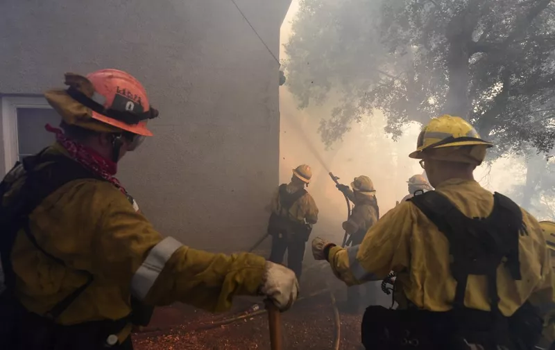 Firefighters work to protect a building at Mt. Wilson Observatory as the Bobcat Fire burns in the Angeles National Forest, northeast of Los Angeles, California on September 17, 2020. - The Bobcat Fire erupted on September 6 near the Cogswell Dam and West Fork Day Use area northeast of Mount Wilson within the Angeles National Forest, expanding from 46,263 acres to 50,539 acres since September 16 while remaining only 3% contained. (Photo by Frederic J. BROWN / AFP)