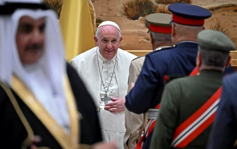 Pope Francis (C) greet dignitaries at the airport in Awali, south of the Bahraini capital Manama, on November 3, 2022. (Photo by Marco BERTORELLO / AFP)