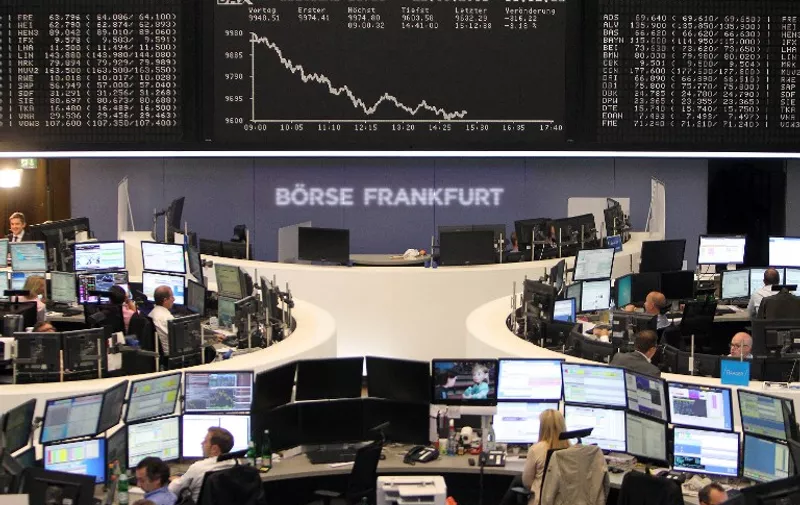 Traders work in front of a board displaying the chart of Germany's share index DAX at the stock exchange in Frankfurt am Main, western Germany, on September 22, 2015. Share prices on the Frankfurt stock exchange fell more than 3.0 percent in midday trading on September 22, 2015, pushed down by index heavyweight Volkswagen, as it ploughed ever deeper into a pollution cheating scandal.     AFP PHOTO / DANIEL ROLAND / AFP PHOTO / DANIEL ROLAND